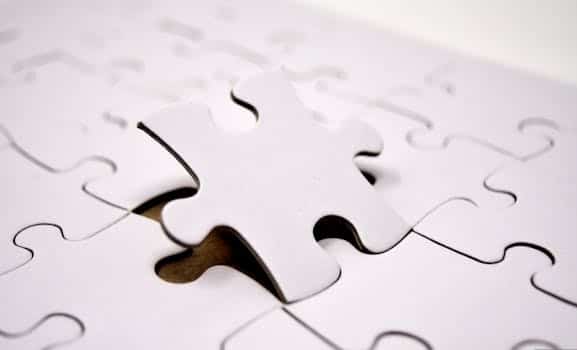 A single white jigsaw puzzle piece fitting into place. Ideal for concepts of problem-solving and solutions.